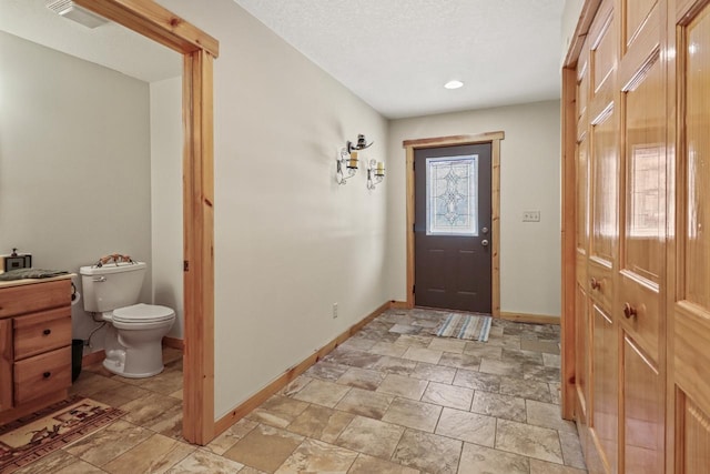 1055 Shishebogama Dr, Minocqua, WI 54548 - foyer entrance featuring baseboards, stone finish flooring, and recessed lighting