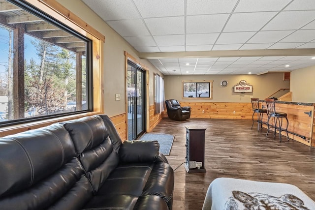 1055 Shishebogama Dr, Minocqua, WI 54548 - living area with a paneled ceiling, wood finished floors, wainscoting, wooden walls, and recessed lighting