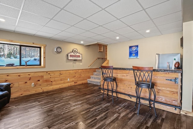 1055 Shishebogama Dr, Minocqua, WI 54548 - indoor dry bar featuring a drop ceiling, freestanding refrigerator, wood finished floors, stairway, and recessed lighting
