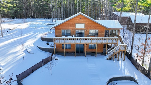 1055 Shishebogama Dr, Minocqua, WI 54548 - view of front of home featuring stairway, a wooded view, and a deck