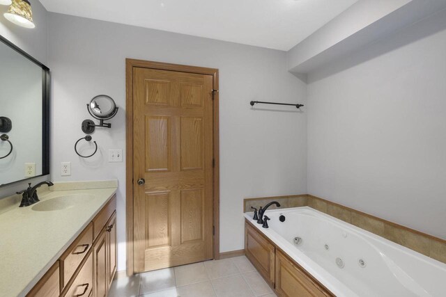 full bathroom featuring tile patterned flooring, vanity, and a tub with jets