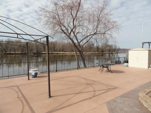 1300 Jack Oak Rd, Cassville, WI 53806 - view of patio with an outdoor structure, fence, a water view, and a shed
