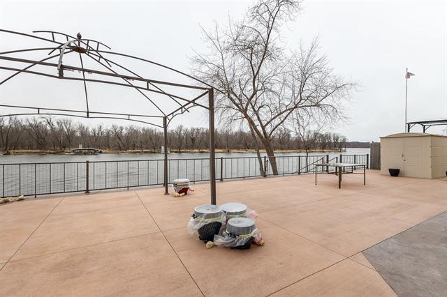 1300 Jack Oak Rd, Cassville, WI 53806 - view of patio / terrace with a water view, a storage shed, an outdoor structure, and fence