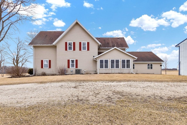 2721 Powder Hill Rd, Slinger, WI 53086 - rear view of house featuring central air condition unit and a lawn