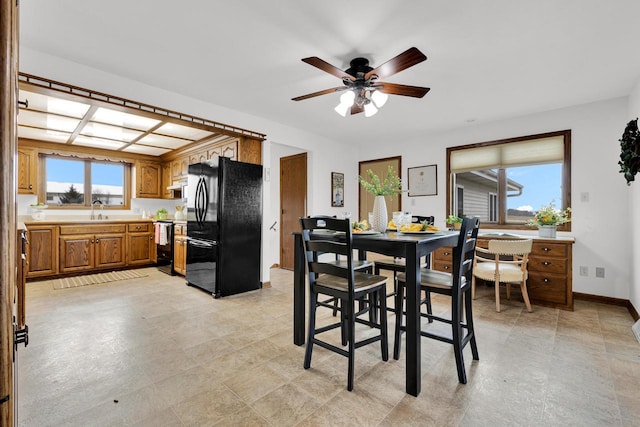 2721 Powder Hill Rd, Slinger, WI 53086 - dining area featuring a wealth of natural light, baseboards, and ceiling fan