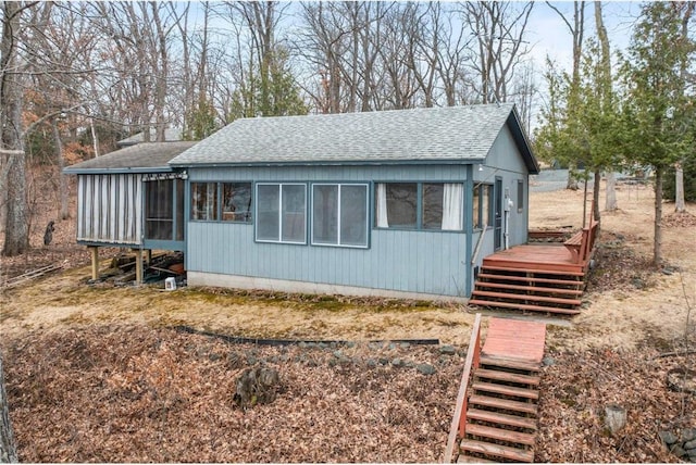 1741A S Deer Lake Cir, Saint Croix Falls, WI 54024 - view of home's exterior with stairs, roof with shingles, a wooden deck, and a sunroom