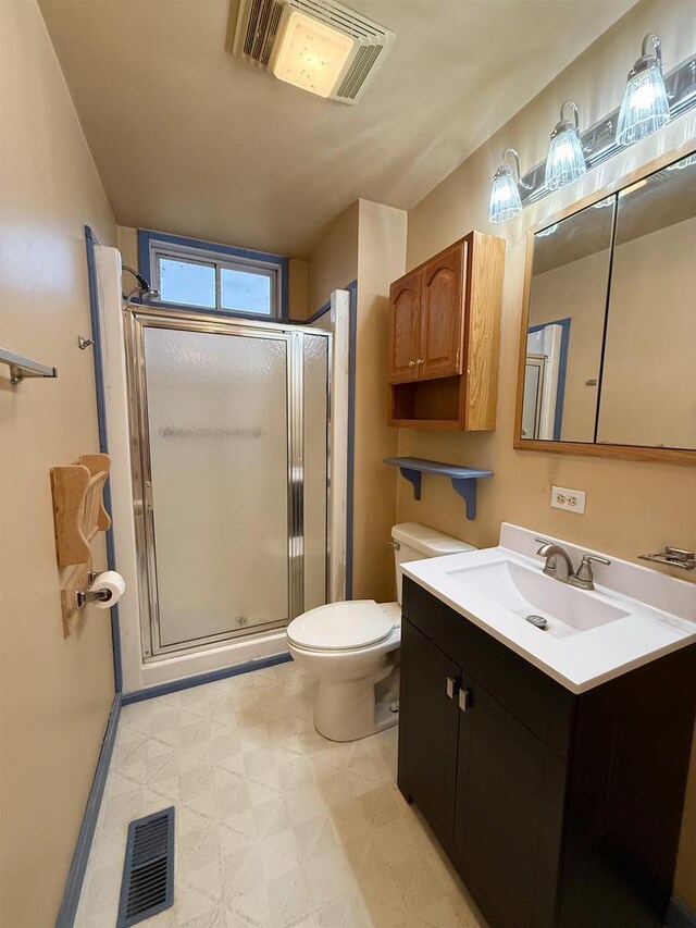 bathroom with vanity, a shower stall, visible vents, and tile patterned floors