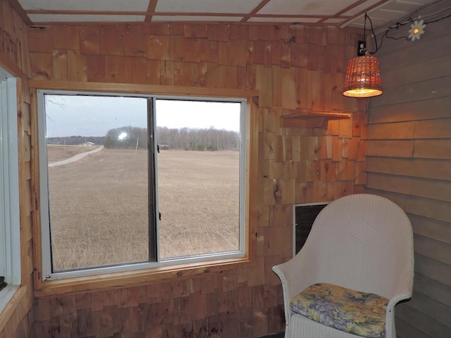 living area featuring wood walls