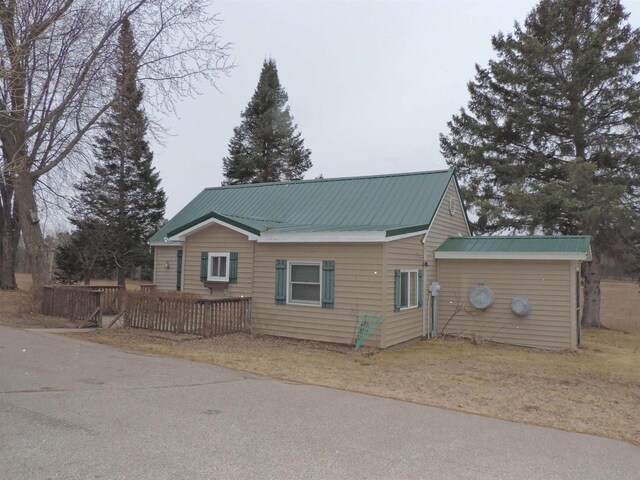 view of front facade with metal roof and fence