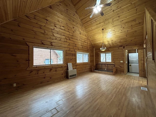 615 Sandy Beach Ct, Warrens, Warrens, WI 54666 - unfurnished living room with wooden walls, wood finished floors, visible vents, and ceiling fan