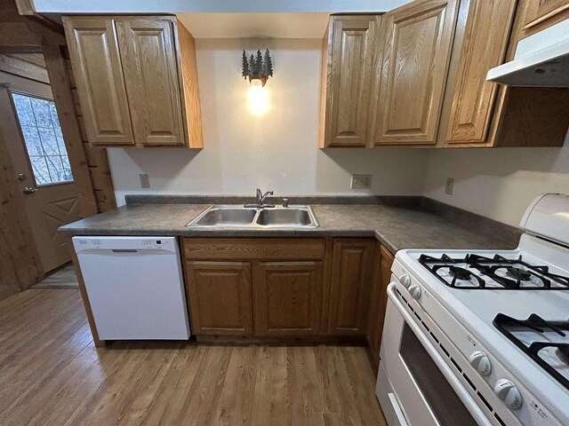 615 Sandy Beach Ct, Warrens, Warrens, WI 54666 - kitchen featuring light wood-type flooring, a sink, under cabinet range hood, dark countertops, and white appliances