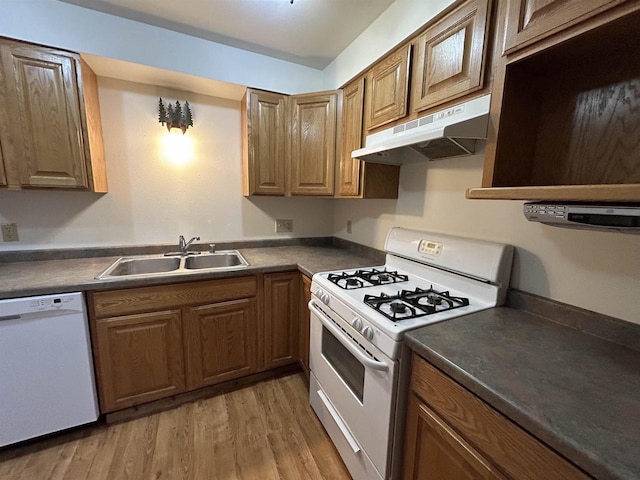 615 Sandy Beach Ct, Warrens, Warrens, WI 54666 - kitchen with white appliances, a sink, light wood-style floors, under cabinet range hood, and dark countertops