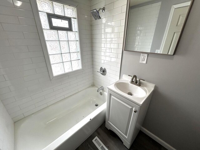 6082 N 36th St, Milwaukee, WI 53209 - bathroom with baseboards, wood finished floors, vanity, and shower / washtub combination