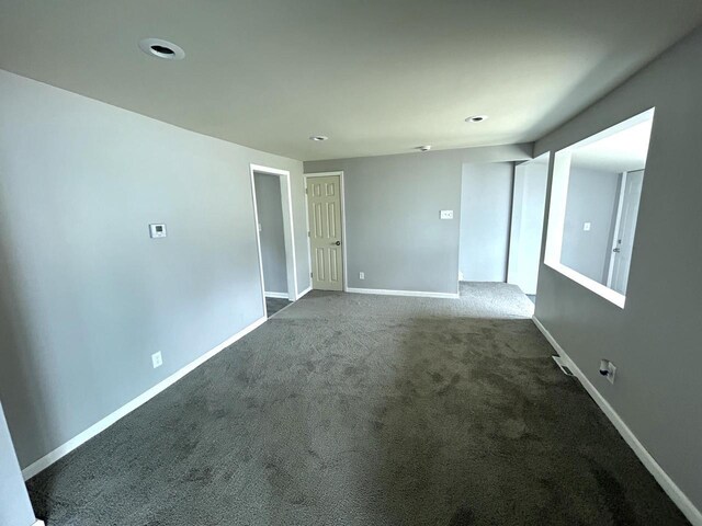 6082 N 36th St, Milwaukee, WI 53209 - spare room with baseboards and dark carpet