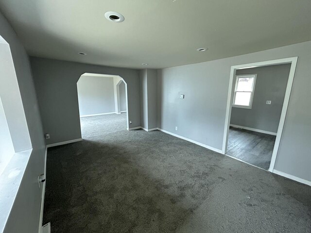 6082 N 36th St, Milwaukee, WI 53209 - empty room with baseboards, arched walkways, and carpet floors