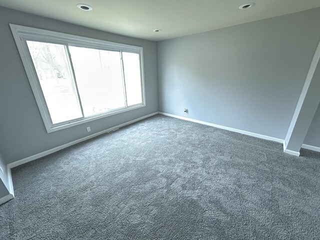 6082 N 36th St, Milwaukee, WI 53209 - unfurnished room with dark colored carpet, baseboards, and recessed lighting