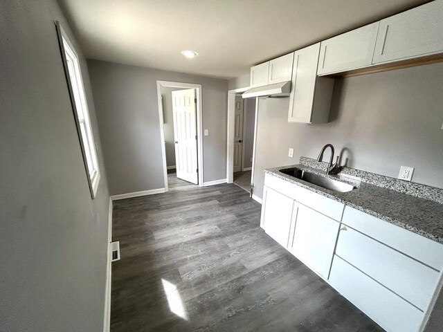 6082 N 36th St, Milwaukee, WI 53209 - kitchen featuring dark wood-type flooring, baseboards, a sink, stone counters, and white cabinets