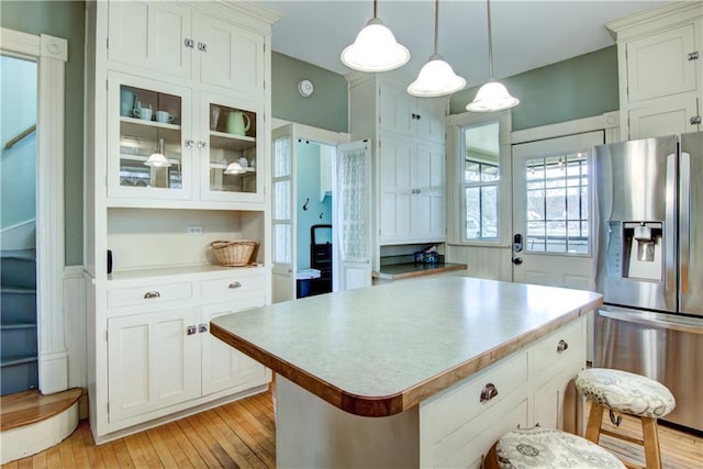 435 Jefferson St, Eau Claire, WI 54701 - kitchen featuring stainless steel fridge with ice dispenser, light wood-style floors, and light countertops
