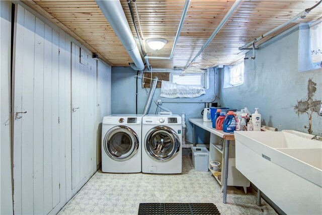 435 Jefferson St, Eau Claire, WI 54701 - clothes washing area with washing machine and clothes dryer, tile patterned floors, wood walls, and wood ceiling