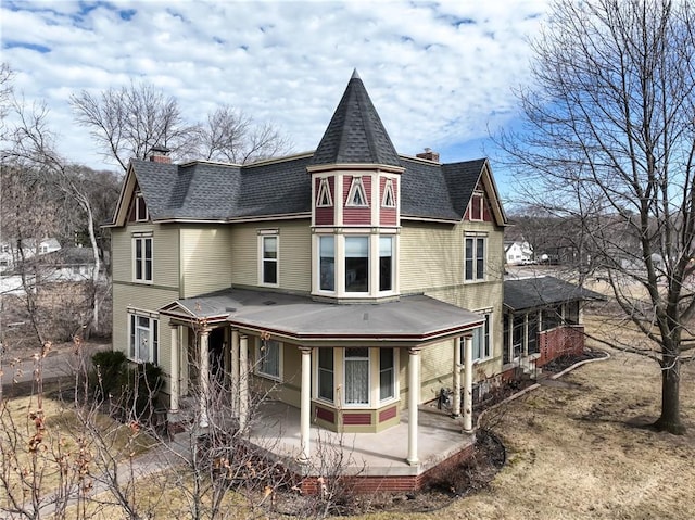 435 Jefferson St, Eau Claire, WI 54701 - rear view of property featuring a chimney and a shingled roof