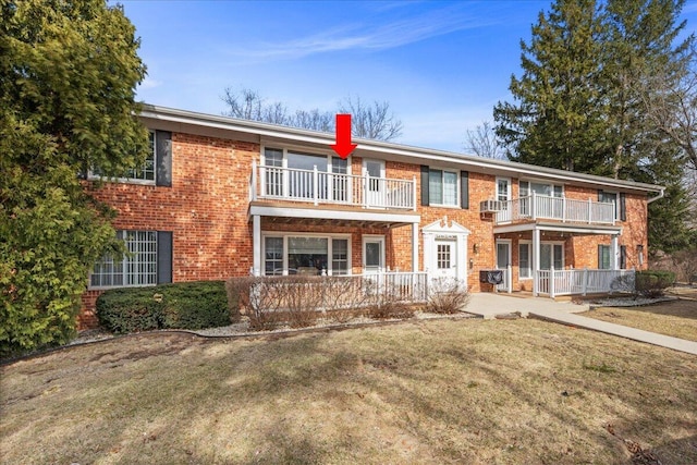 502 Laurel Lake Rd Unit 5, Thiensville, WI 53092 - view of front of property with a porch, a front yard, a balcony, and brick siding