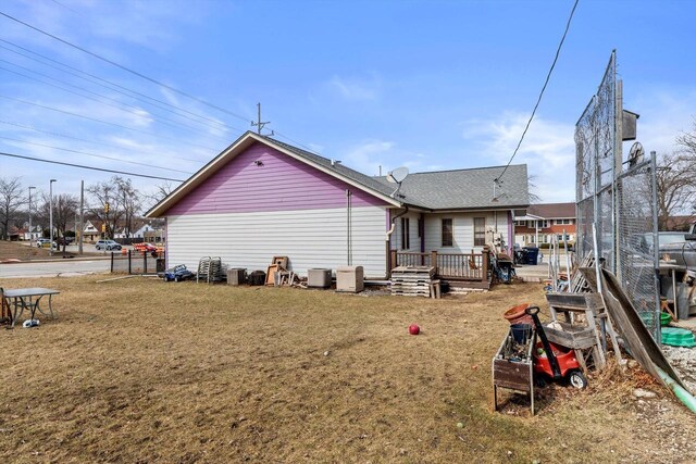 4229 W Howard Ave, Milwaukee, WI 53221 - back of house with a lawn, a wooden deck, and roof with shingles