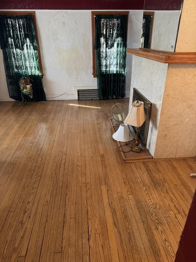 7126 W Congress St, Milwaukee, WI 53218 - unfurnished living room featuring visible vents, a textured wall, and wood-type flooring
