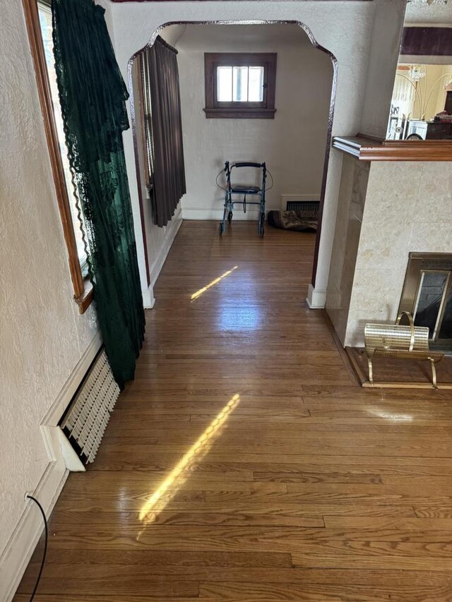 7126 W Congress St, Milwaukee, WI 53218 - hallway featuring arched walkways, visible vents, a textured wall, and wood finished floors