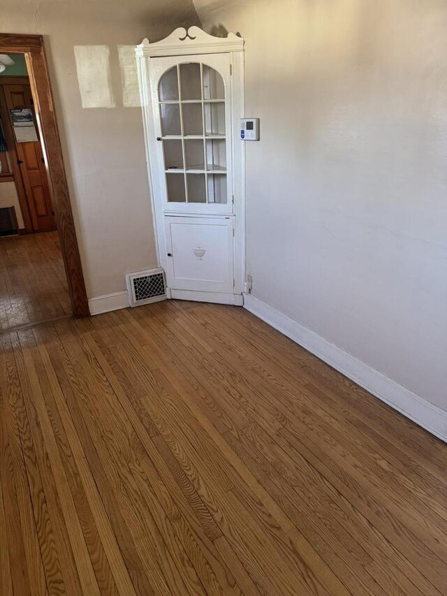 7126 W Congress St, Milwaukee, WI 53218 - unfurnished room featuring visible vents, baseboards, and hardwood / wood-style flooring