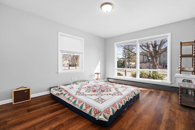 1-3 Mechanic St, Edgerton, WI 53534 - bedroom featuring a baseboard radiator, baseboards, and wood finished floors