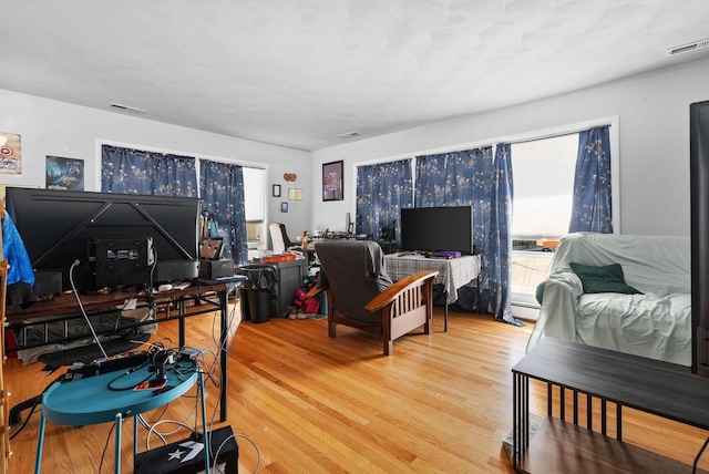 1-3 Mechanic St, Edgerton, WI 53534 - living room with a baseboard radiator, visible vents, and wood finished floors