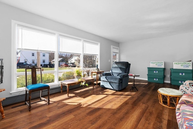 1-3 Mechanic St, Edgerton, WI 53534 - living area featuring baseboard heating, baseboards, and wood finished floors