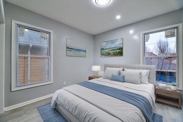 bedroom with light wood-style floors and baseboards
