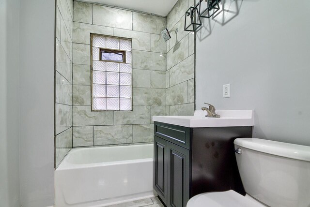 bathroom with vanity, bathtub / shower combination, and toilet