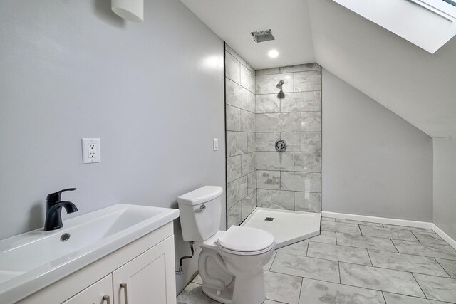 bathroom featuring baseboards, vaulted ceiling, toilet, visible vents, and a tile shower