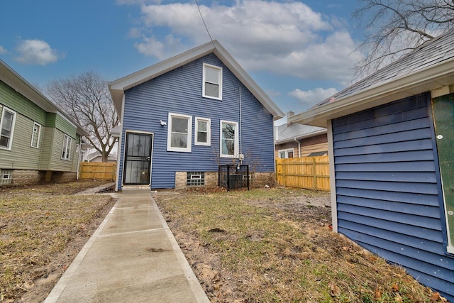 rear view of property with fence