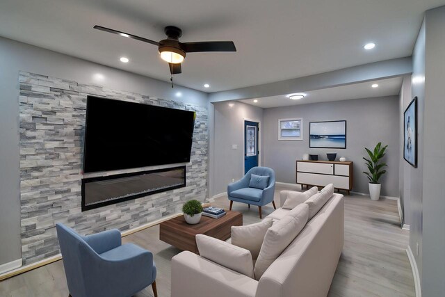 living area with wood finished floors, baseboards, a ceiling fan, and recessed lighting