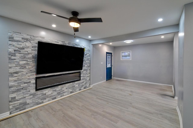 unfurnished living room with ceiling fan, recessed lighting, wood finished floors, and baseboards