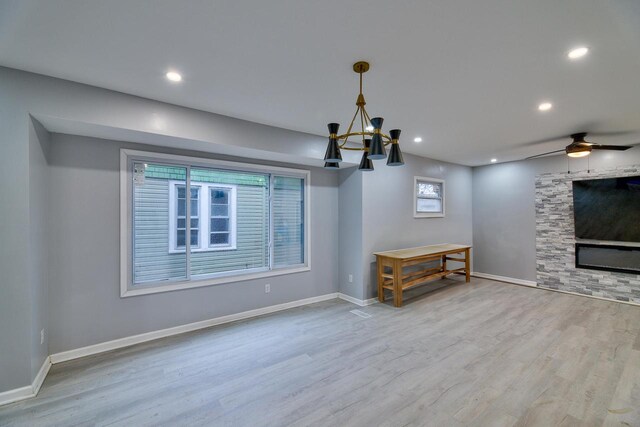 unfurnished living room featuring baseboards, recessed lighting, and wood finished floors