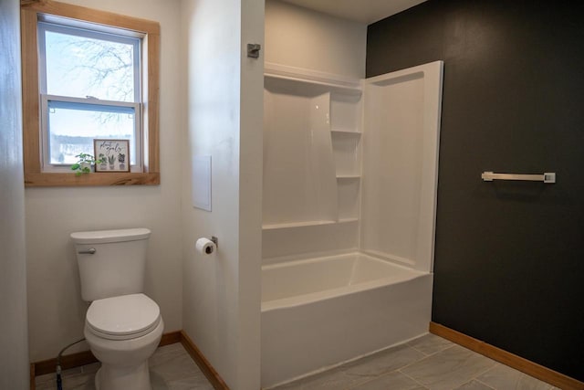 N2547 County Road G, Mauston, WI 53948 - bathroom featuring toilet, baseboards, and shower / bathing tub combination