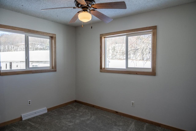 N2547 County Road G, Mauston, WI 53948 - spare room with a textured ceiling, a ceiling fan, baseboard heating, dark colored carpet, and baseboards
