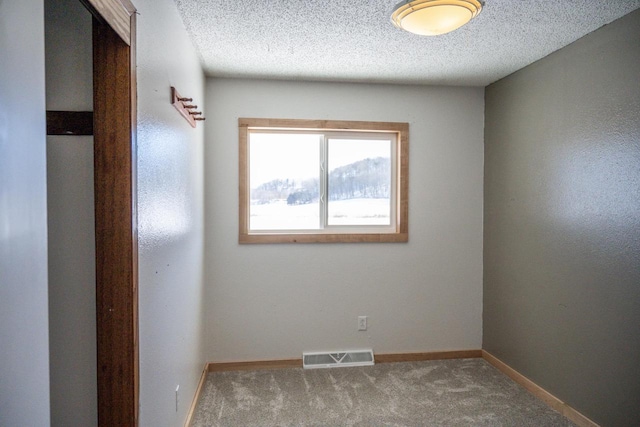 N2547 County Road G, Mauston, WI 53948 - empty room with visible vents, baseboards, carpet floors, and a textured ceiling