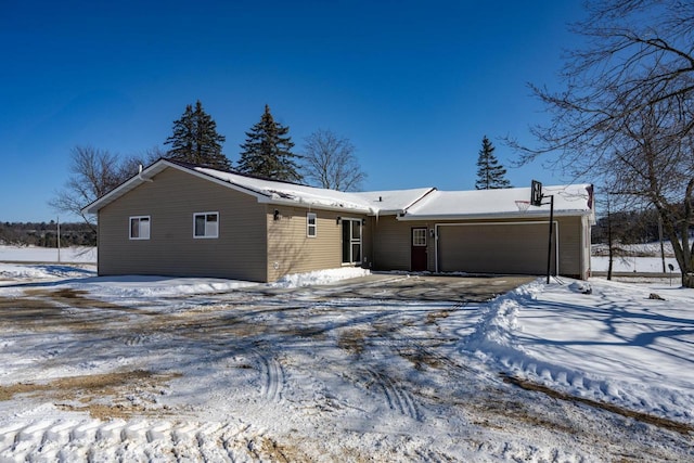 N2547 County Road G, Mauston, WI 53948 - snow covered back of property with driveway and a garage