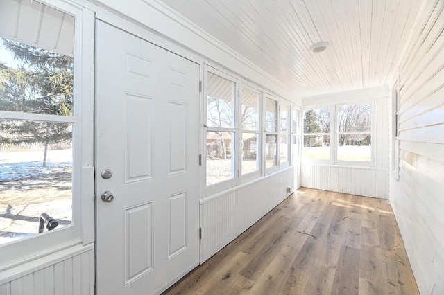 sunroom / solarium with wood ceiling and wood finished floors