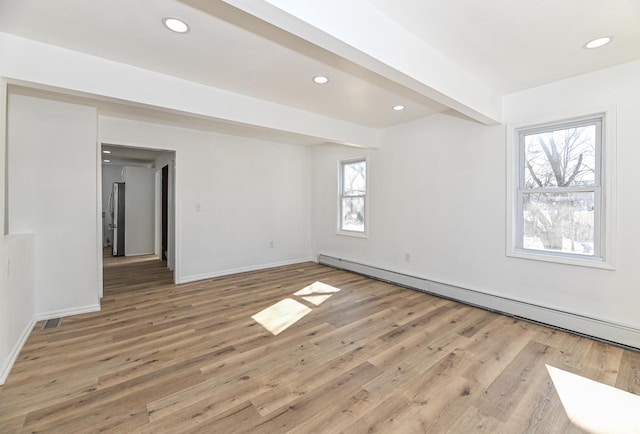 unfurnished room with light wood finished floors, beamed ceiling, recessed lighting, and a baseboard heating unit