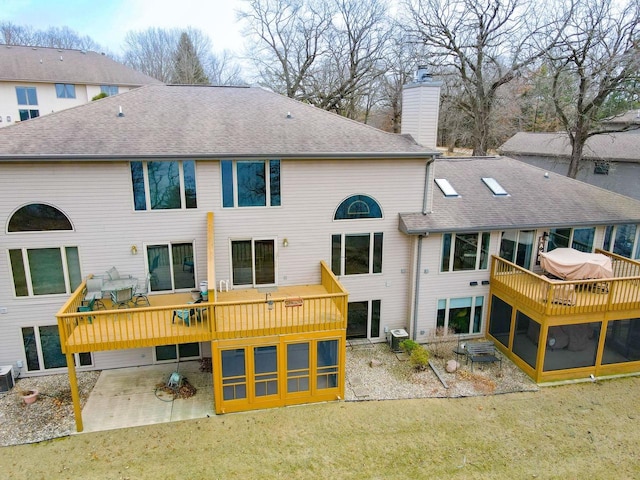 N761 Waubunsee Trl Unit 2, Fort Atkinson, WI 53538 - back of house with a wooden deck, a chimney, a yard, and a patio