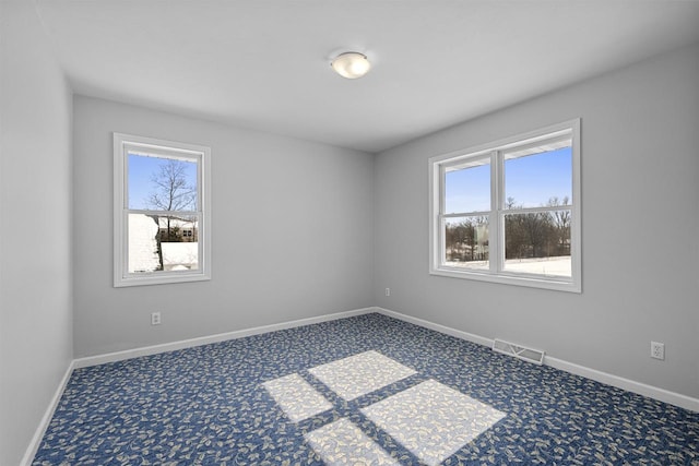 2155 Cottonwood Dr, Menasha, WI 54952 - carpeted empty room featuring baseboards, visible vents, and a wealth of natural light