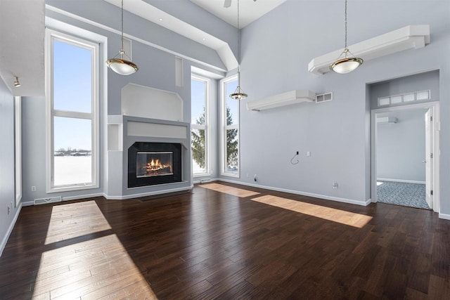 2155 Cottonwood Dr, Menasha, WI 54952 - unfurnished living room featuring a wealth of natural light, visible vents, and wood-type flooring
