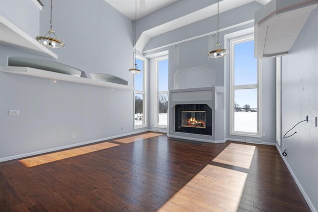 2155 Cottonwood Dr, Menasha, WI 54952 - unfurnished living room featuring a glass covered fireplace, visible vents, baseboards, and hardwood / wood-style floors