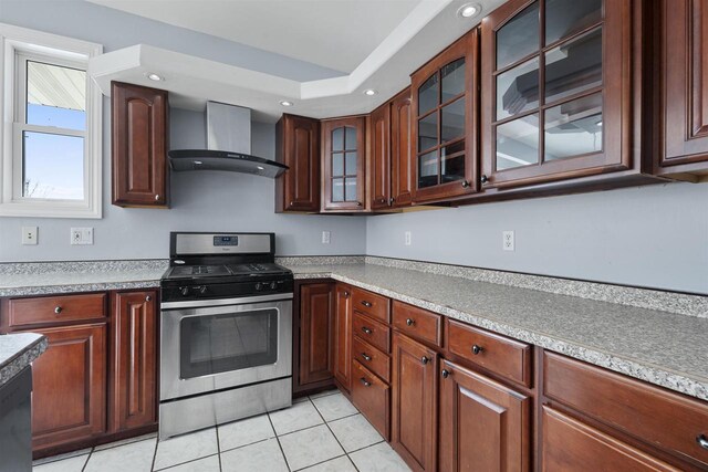 2155 Cottonwood Dr, Menasha, WI 54952 - kitchen with glass insert cabinets, stainless steel range with gas cooktop, wall chimney range hood, light countertops, and light tile patterned floors